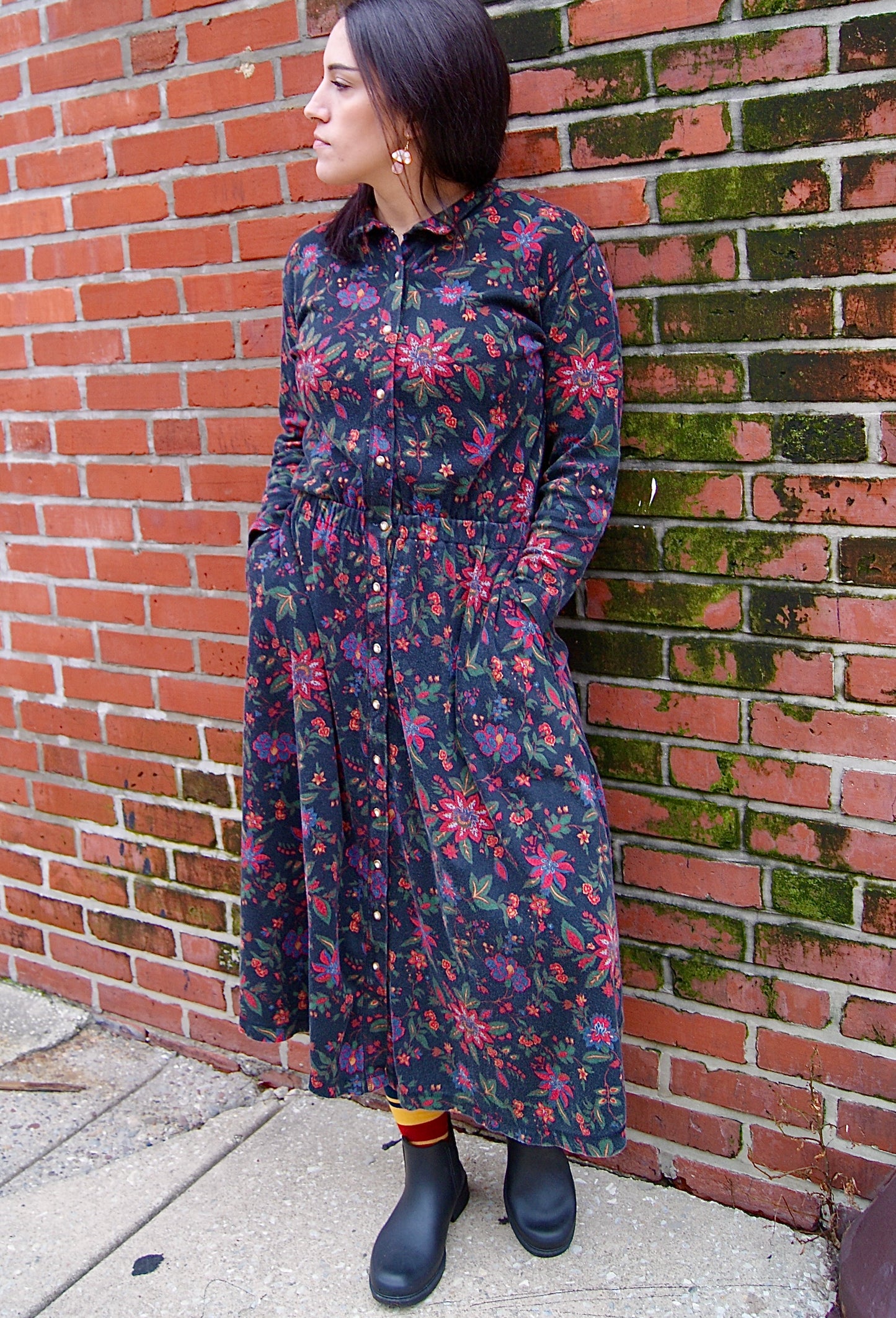 long dress with long sleeves and fitted elastic waist, featuring a red & yellow floral print on black jersey material