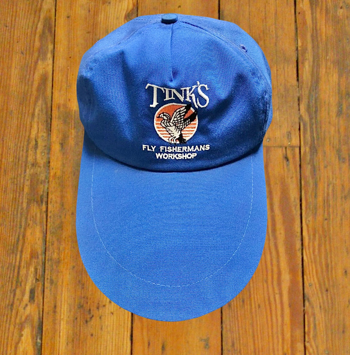vintage blue fishing cap with extra long bill and "Tink's Fly Fisherman's Workshop" graphic