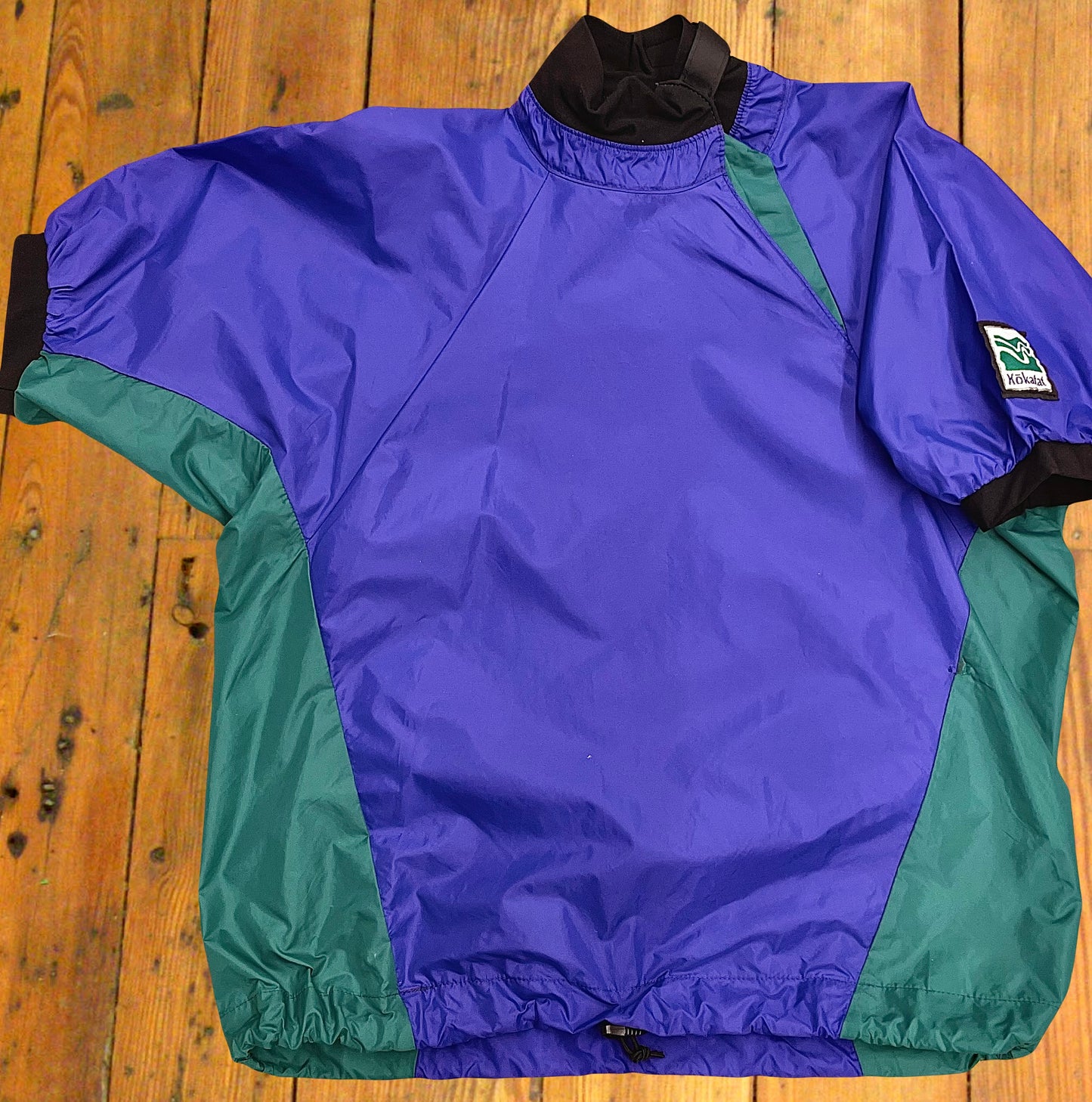 vintage Kokatat dry top designed for kayakers, in a great purple-teal colorway. With Velcro-adjustable collar & cinching bottom.