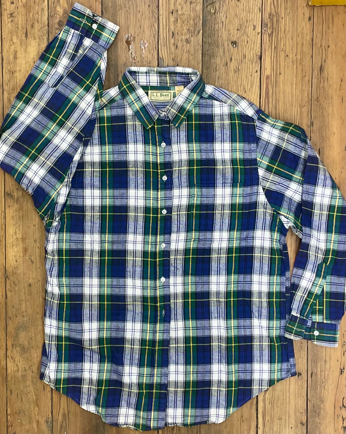 traditional plaid flannel shirt with mostly blue plus white, yellow, green