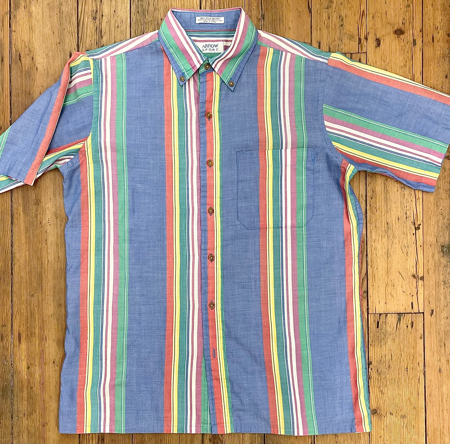 primarily blue vintage short-sleeve shirt with red-pink-yellow-green verticle stripes