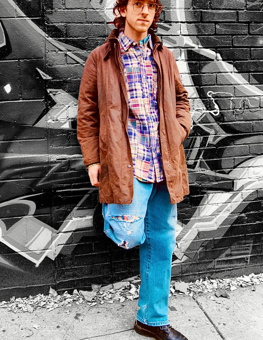Distressed medium-wash jeans with light whispering & fading. All major structural damage repaired including a large floral pattern patch on the knee taken from a vintage Orvis skirt & other visible mending.