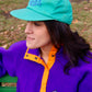 Eddie Bauer high-crown, structured cap in turquoise color with vintage goose logo in purple