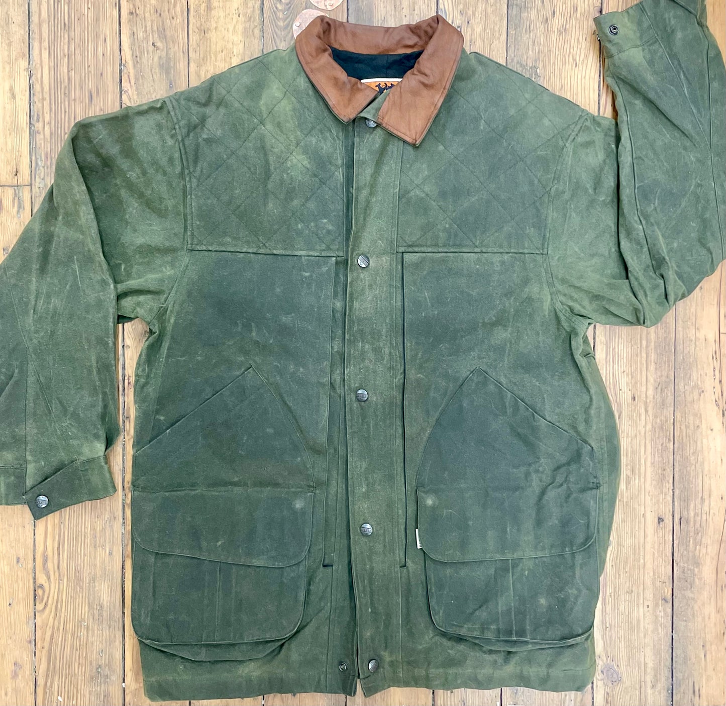 Green waxed canvas jacket with leather collar from Australian brand. 