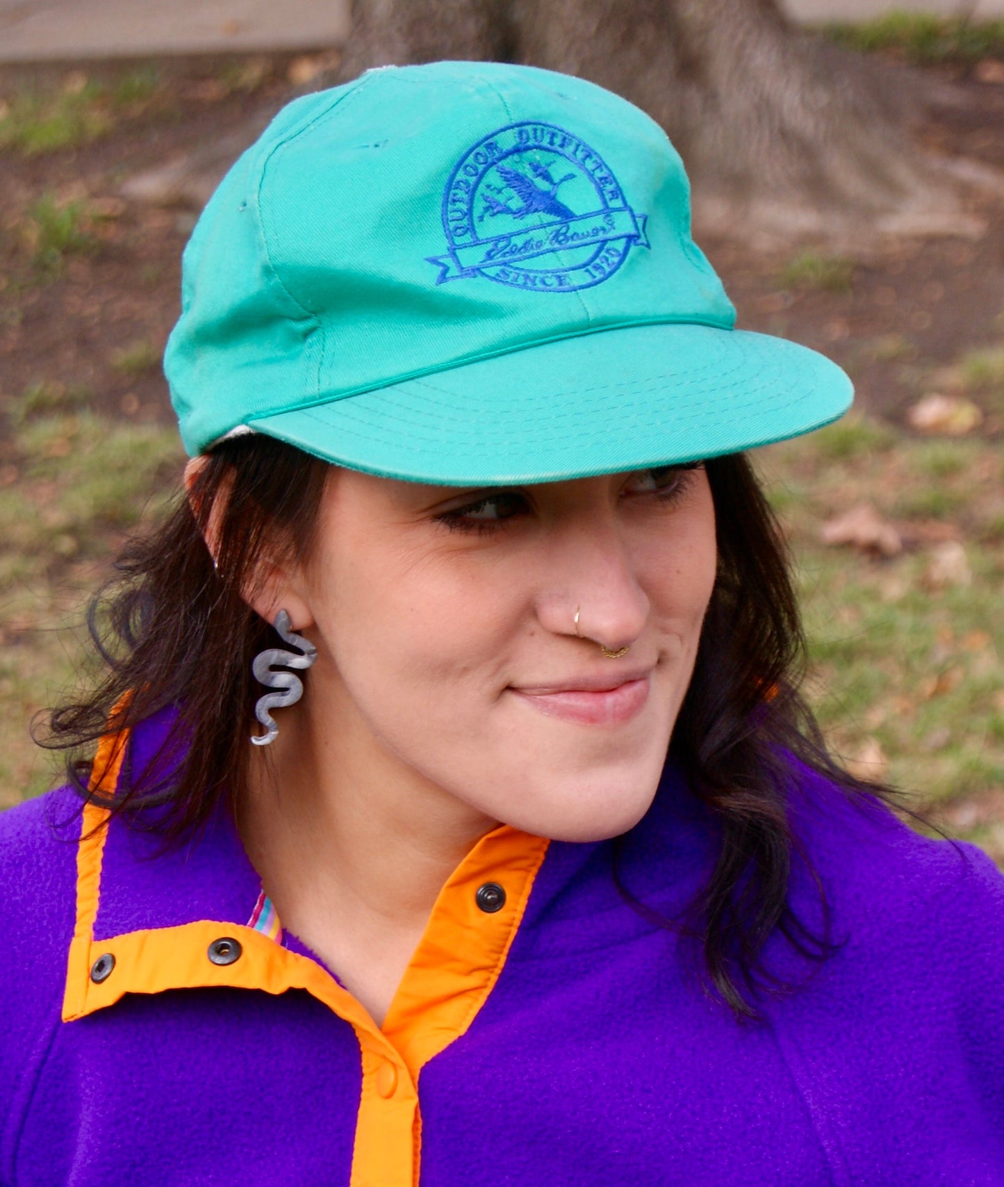 Eddie Bauer high-crown, structured cap in turquoise color with vintage goose logo in purple