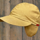 unbranded vintage tan canvas cap with fold-away ear flaps & convertible panel that allows you to change the hat’s color to red.