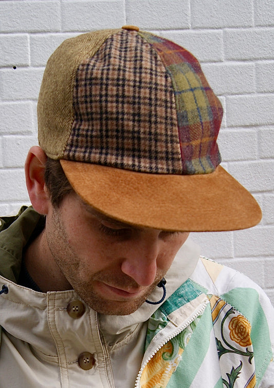 Vintage wool-blend cap with earth-toned patchwork design. 