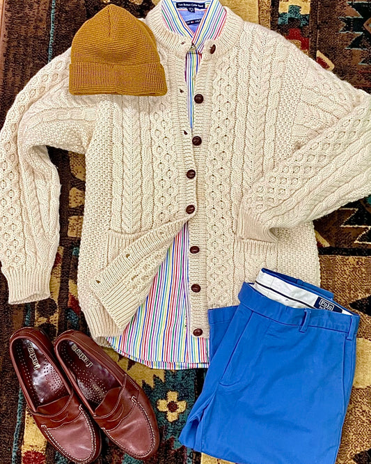 wool cable-knit cardigan sweater styled with a pair of penny loafers, blue chinos & pinstripe shirt 