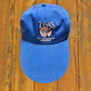 vintage blue fishing cap with extra long bill and "Tink's Fly Fisherman's Workshop" graphic 