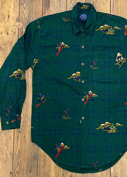 dark green flannel shirt with large navy checks & skiing figures print incorporated into pattern