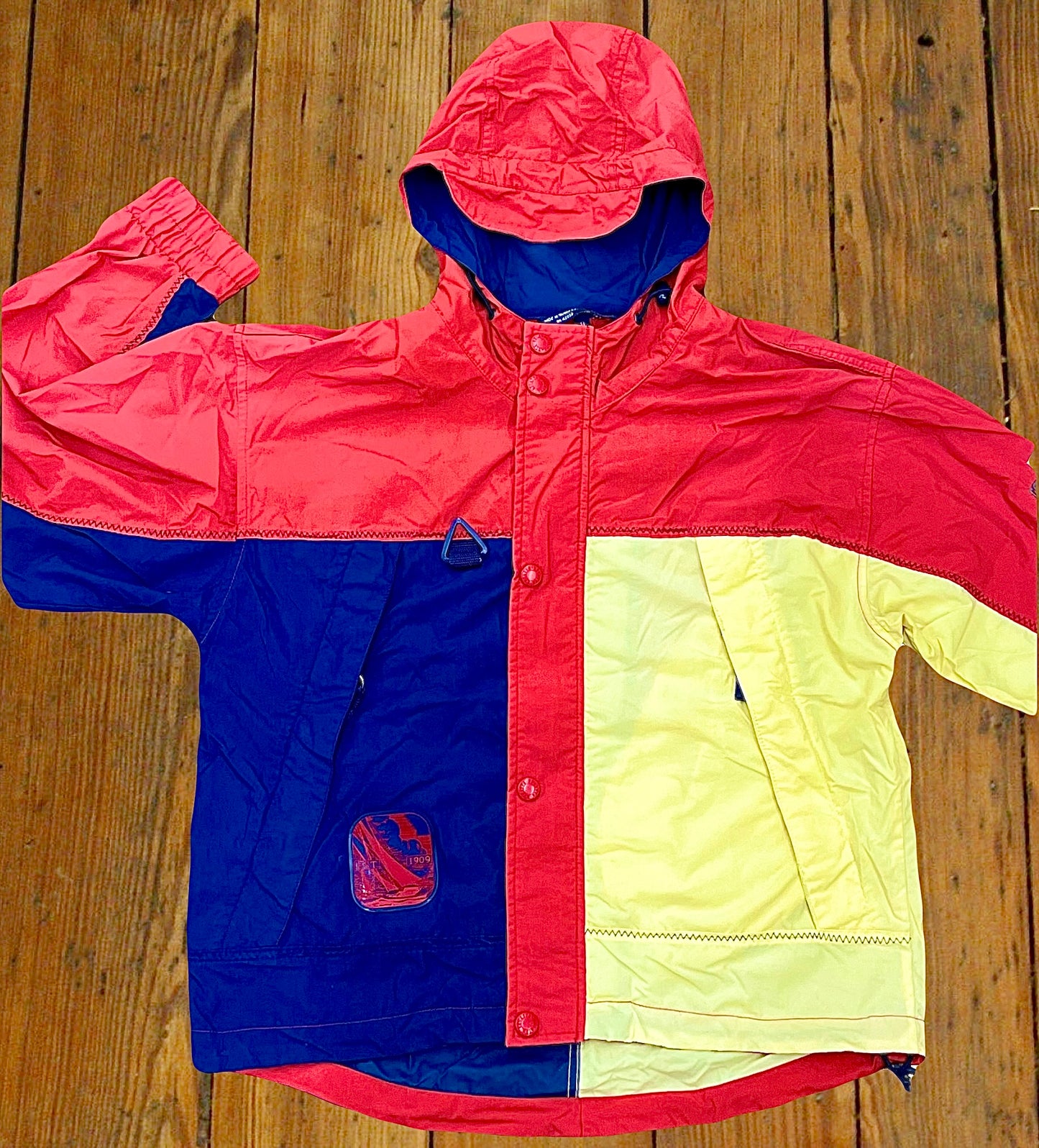 Regatta Sport brand full-zip windbreaker in a red, yellow, and blue color-way.