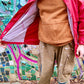 Male model wears one-of-a-kind tan Carhartt cargo work pants with uinique patchwork repair from a Mexican traditional blanket