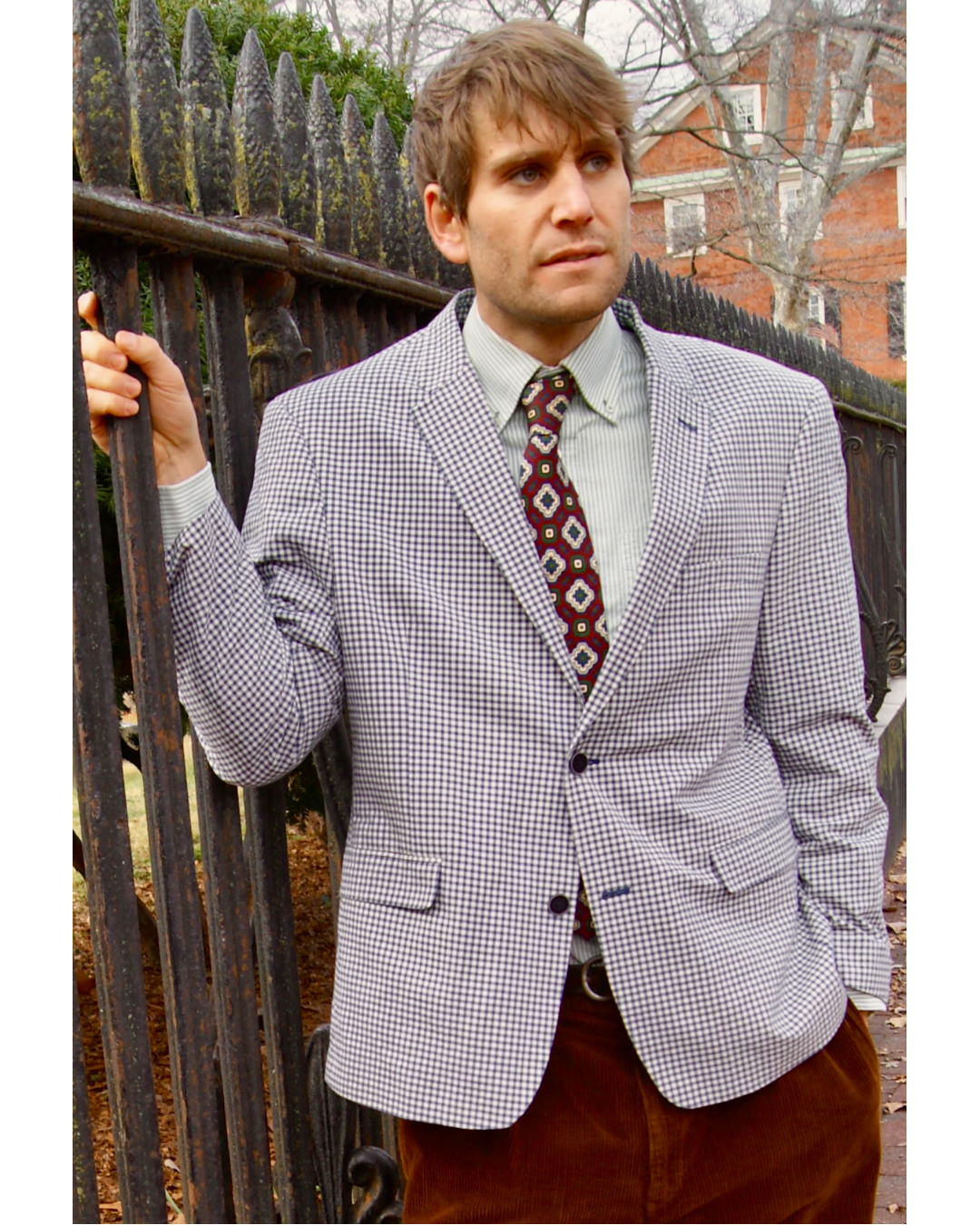 Model wears Tommy Hilfiger Men's Blue Gingham Blazer with brown corduroy pants