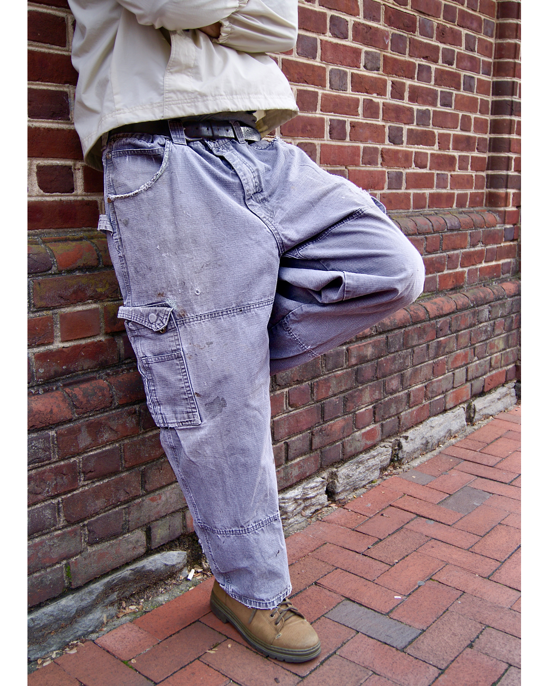 Distressed duck canvas work pants with small patch details using vintage floral-print fabric taken from an Orvis skirt, as well as mending on major structural damage.